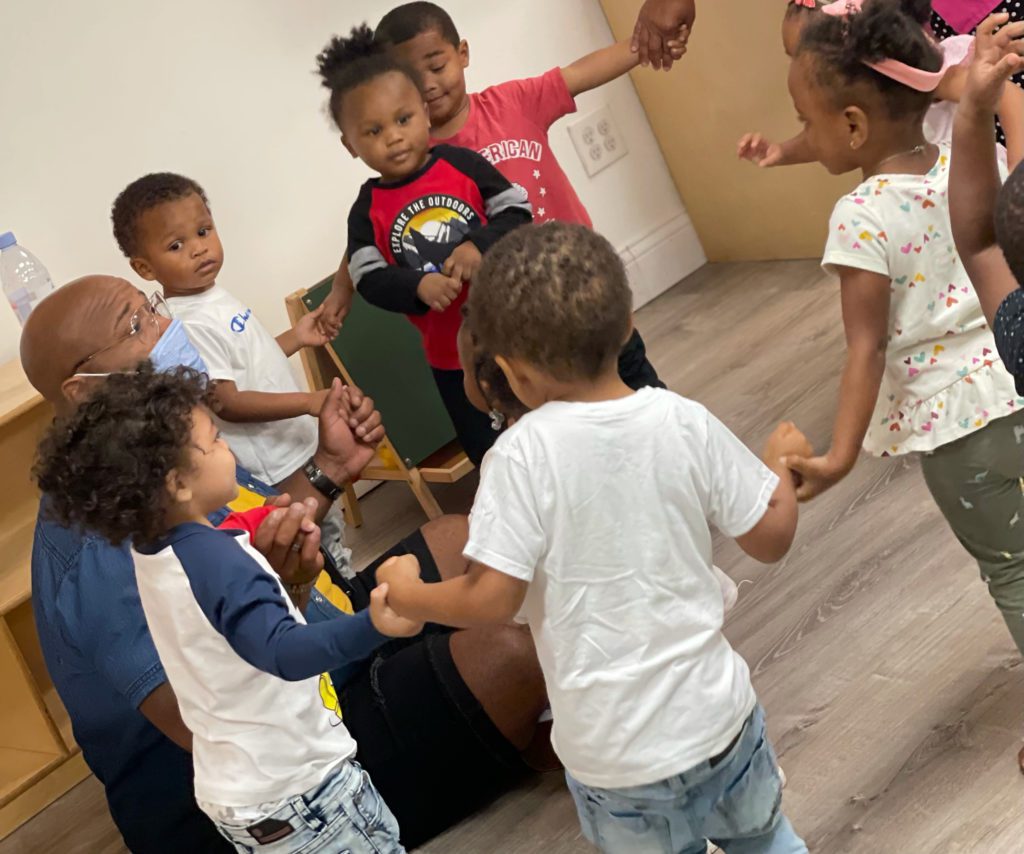 Children at SELF hold hands during circle time