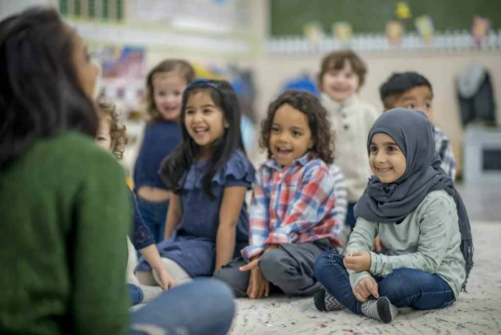 A Diverse Group of Students Listening To Teacher