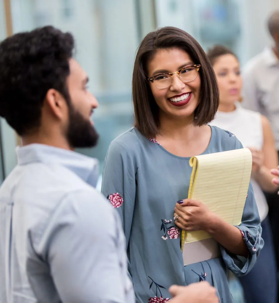 Teachers gather and chat between sessions at a conference.