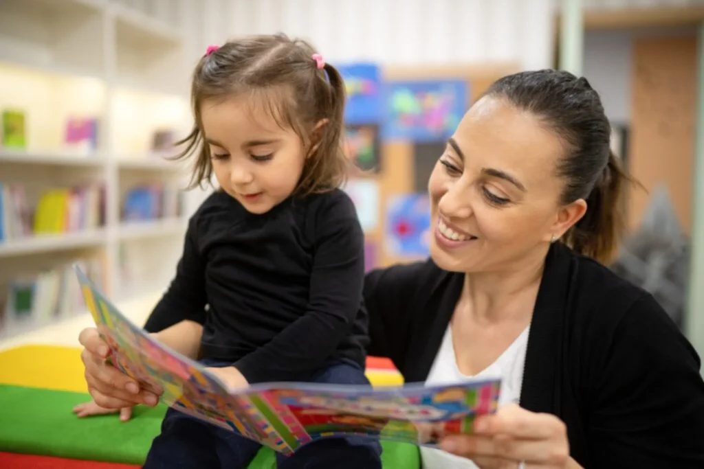 Teacher and child reading together