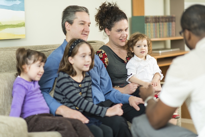A teacher meets with a family with 3 young children in their home.